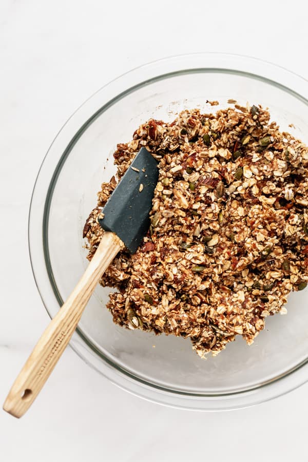 a clear mixing bowl with superfood granola bars ingredients in it