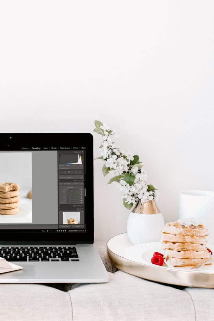 A laptop and a plate of waffles on a couch