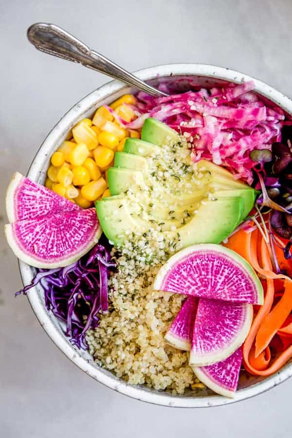 A rainbow buddha bowl with red cabbage, radishes and beets