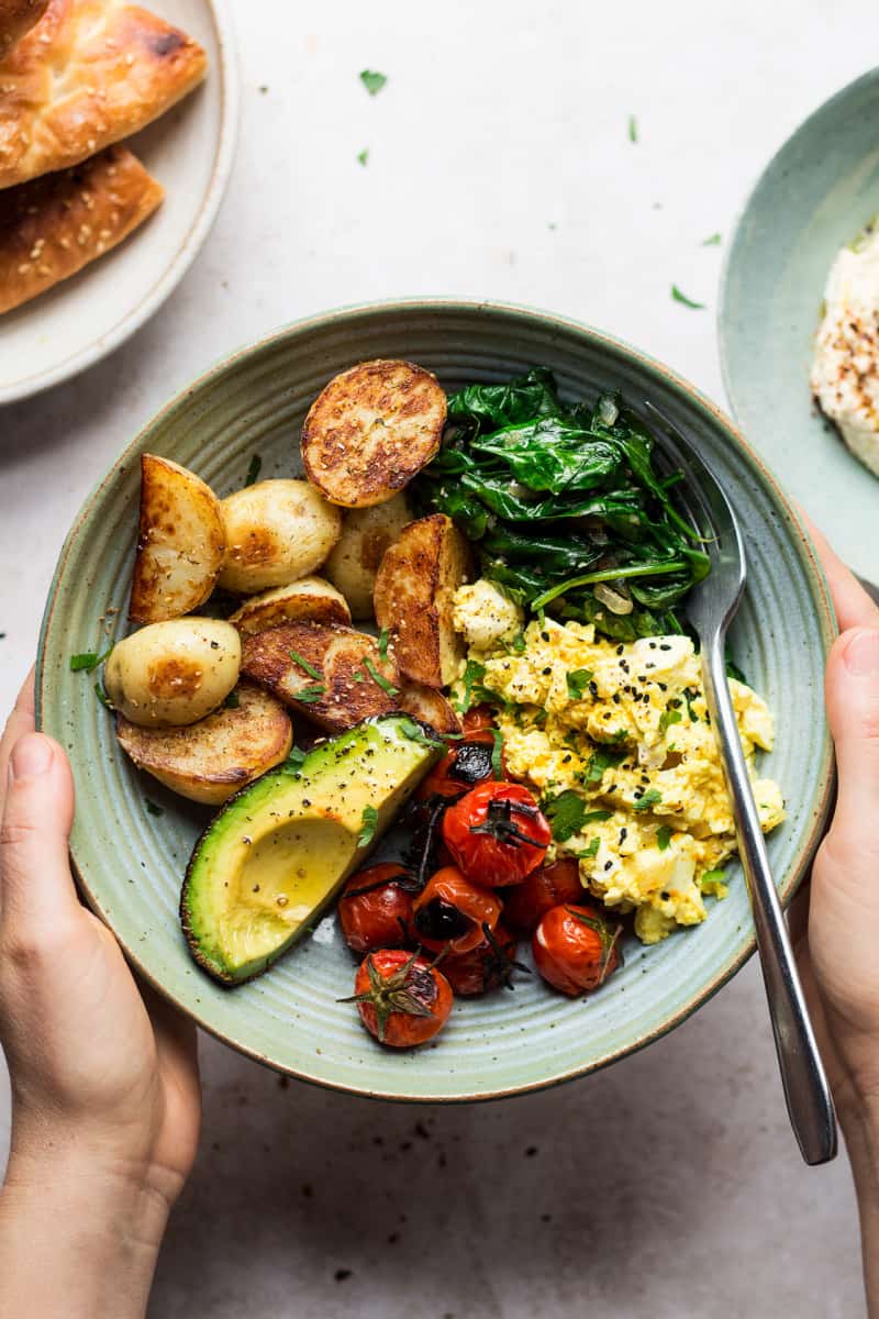 A savoury vegan breakfast bowl with scrambled tofu and potatoes