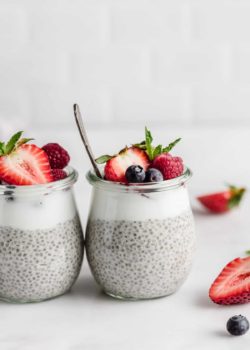a cup of chia pudding with berries and a spoon in it