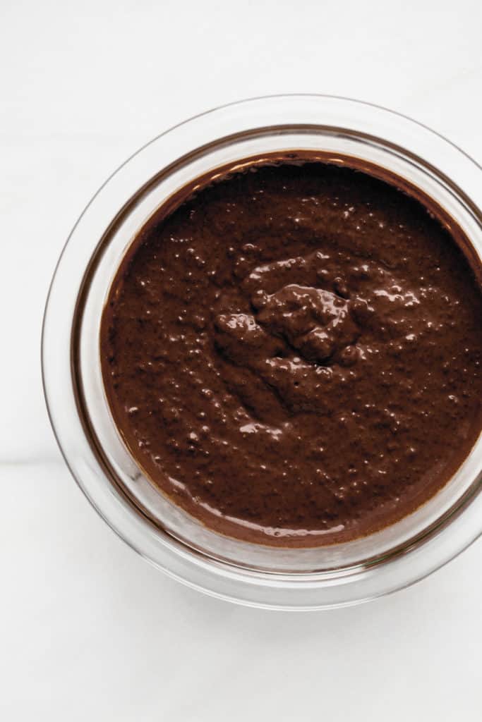 chocolate chia pudding in a clear mixing bowl