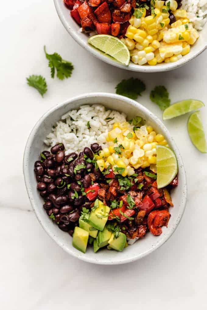 A vegan burrito bowl with beans, corn and peppers