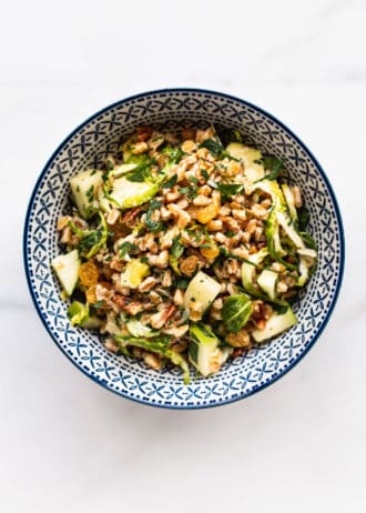 a blue and white bowl with farro salad in it