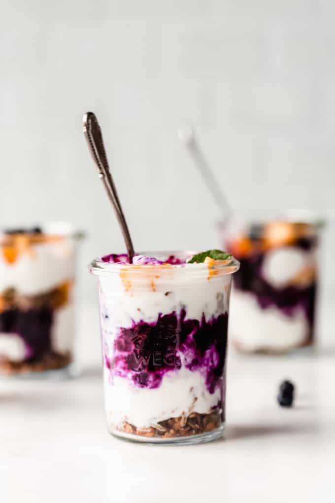 cup filled wth yogurt and blueberry compote