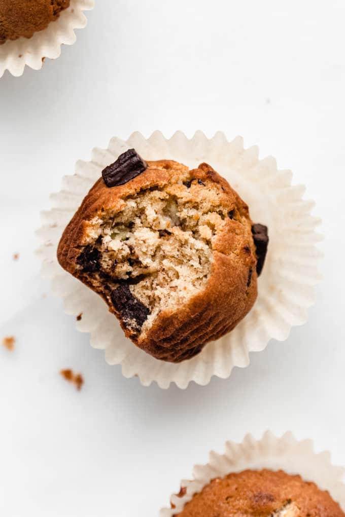 a chocolate chunk banana muffin with a bite taken out of it
