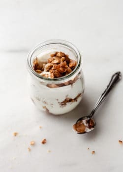 a jar of apple pie parfait with a spoon on the side