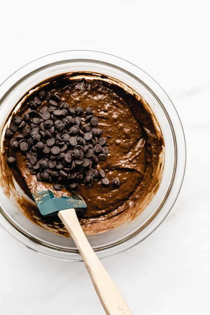 A bowl of chocolate pumpkin bread batter with chocolate chips on top