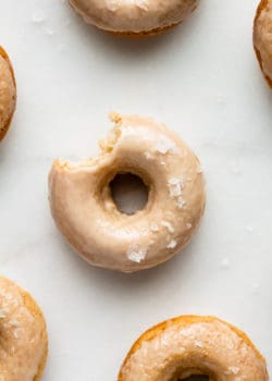 Maple donuts on a marble board topped with sea salt