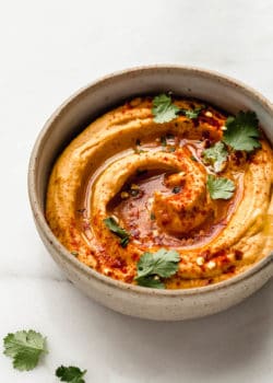 sweet potato hummus in a speckled ceramic bowl