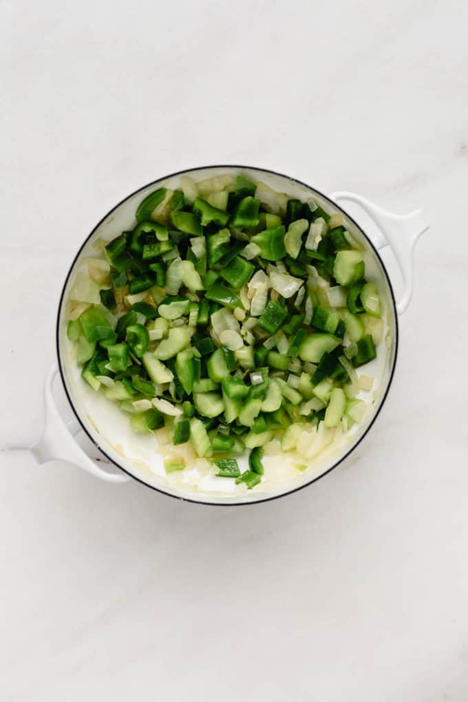 chopped green peppers and onions in a white pot