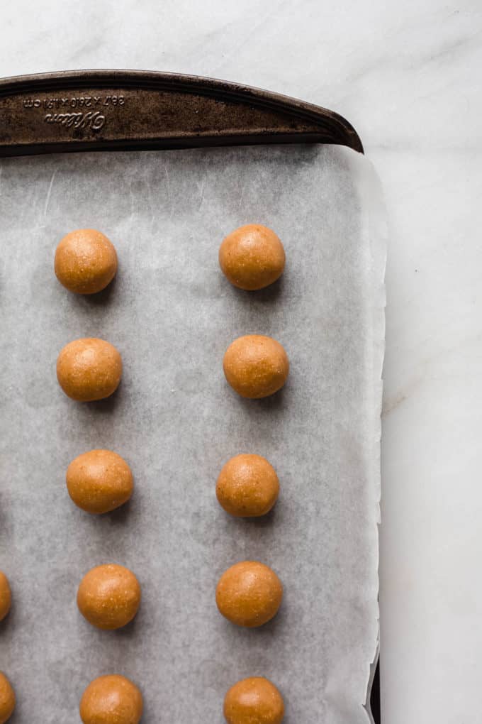 Peanut butter balls on a baking sheet