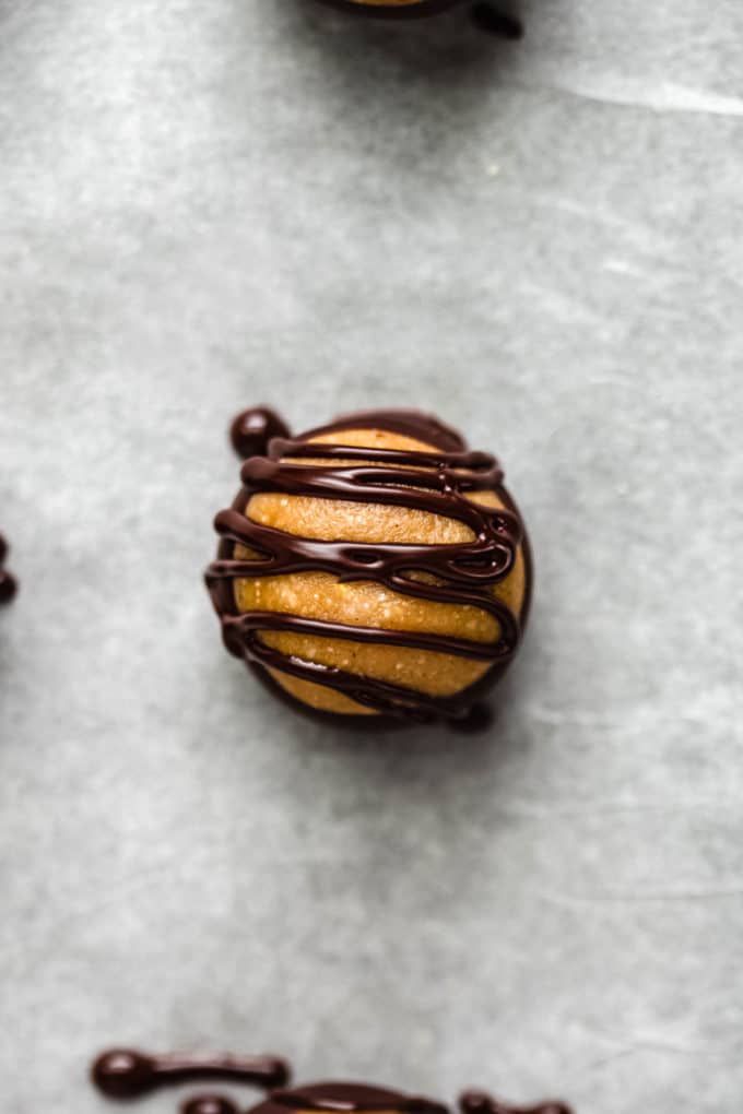 A healthy peanut butter buckeye drizzled with dark chocolate