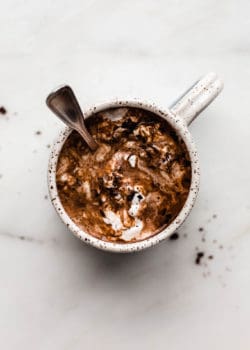 A mug of hot chocolate with a spoon in it