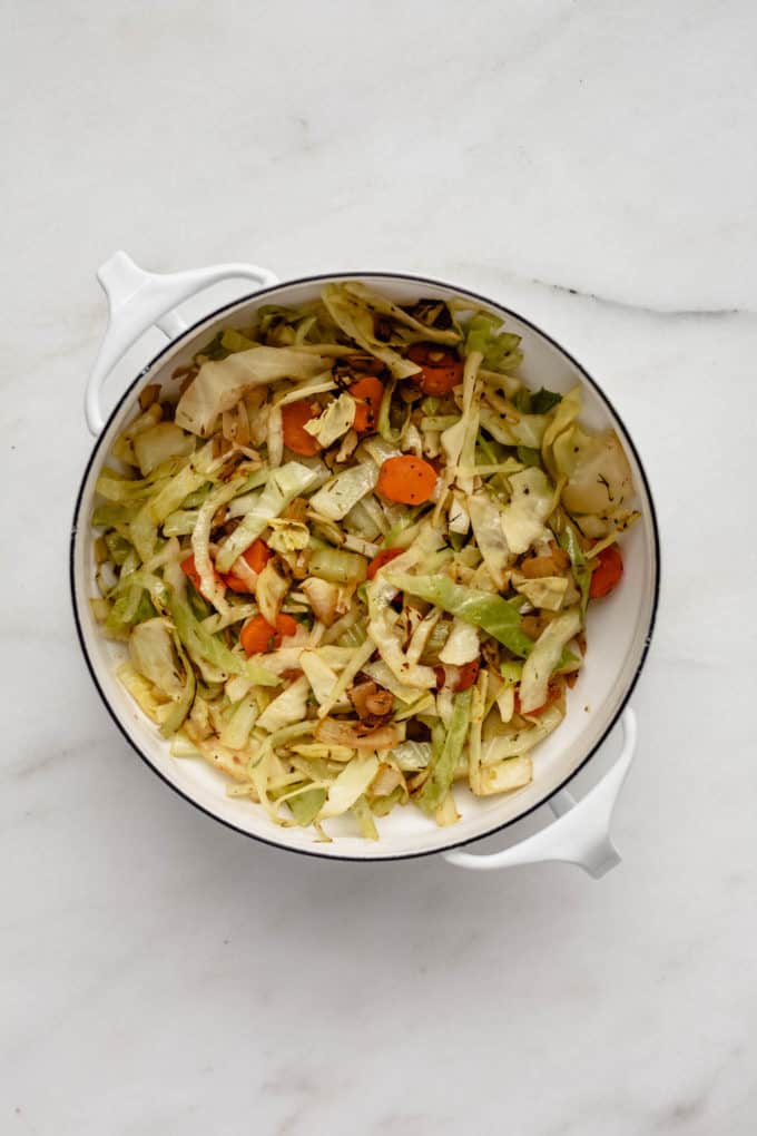 shredded cabbage and vegetables in a white pot
