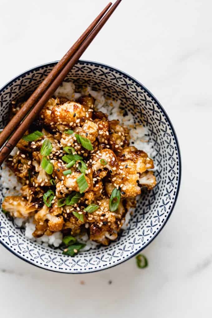 kung pao cauliflower topped with green onions and sesame seeds