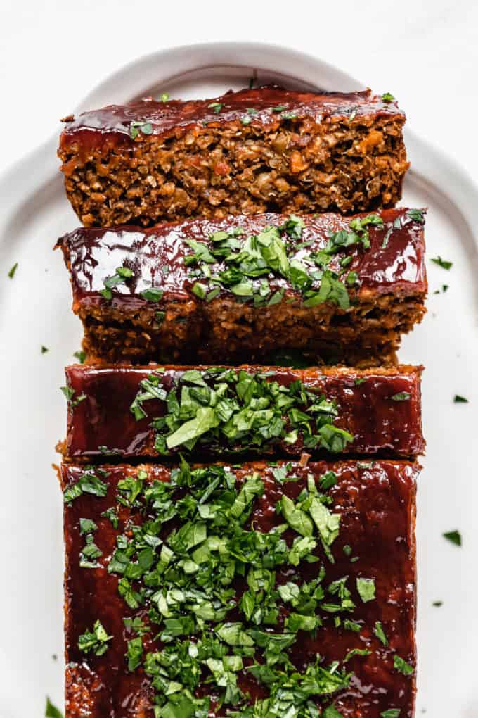 A vegan lentil loaf topped with a ketchup glaze and parsley