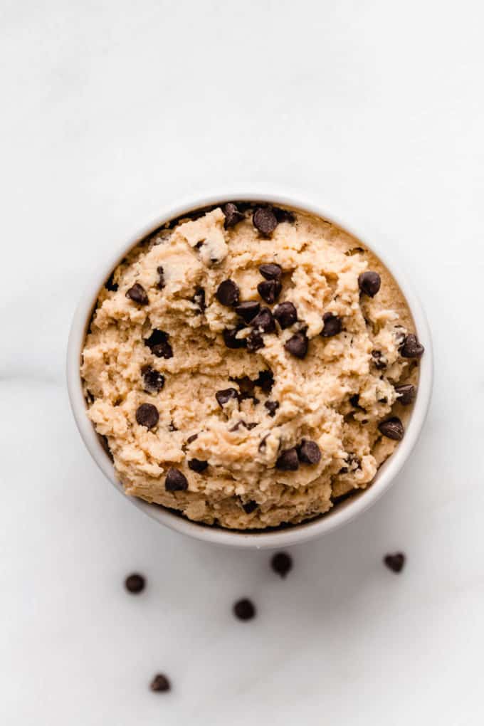 chickpea cookie dough in a small bowl with chocolate chips on top