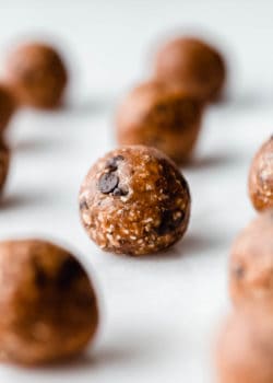 A peanut butter protein ball on a marble board
