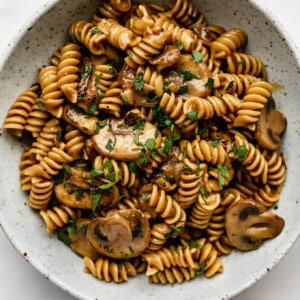 vegan mushroom stroganoff in a white speckled ceramic bowl