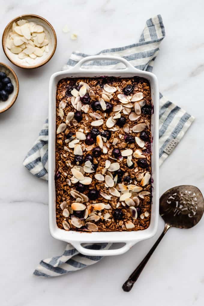 A baking dish with blueberry baked oatmeal in it on a blue napkin
