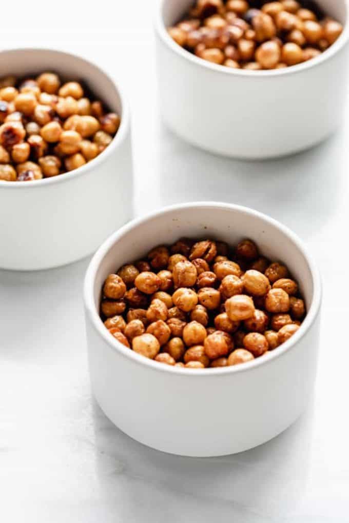 three small bowls with roasted chickpeas in them
