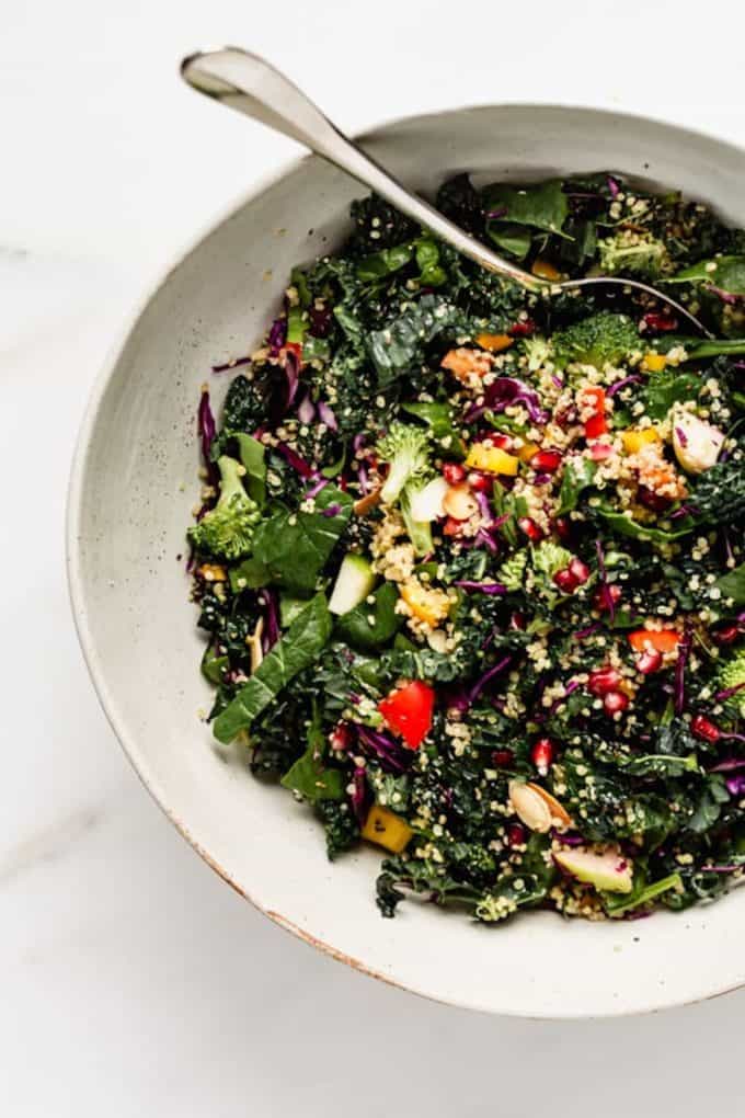 A kale salad with hemp seeds in a large bowl