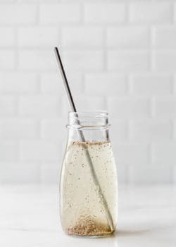 a chia seed drink in a jar with a metal straw