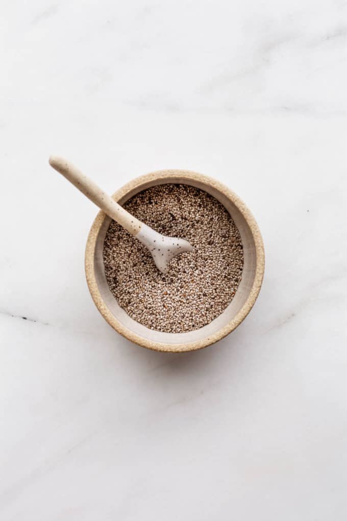 white chia seeds in a small ceramic bowl