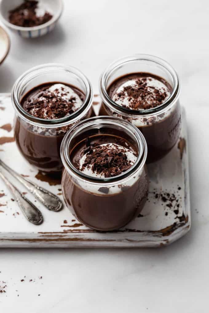 three chocolate pots topped with yogurt and dark chocolate