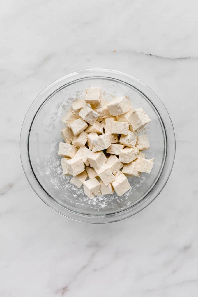 cubed tofu in a clear mixing bowl