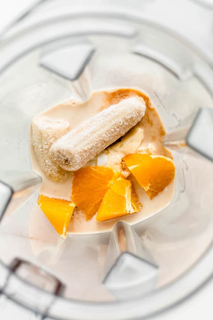banana, oranges, and almond milk in a blender