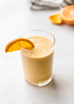an orange creamsicle smoothie with an orange slice in it