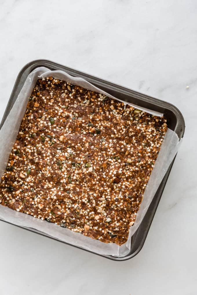 puffed quinoa and nut bars in a baking pan