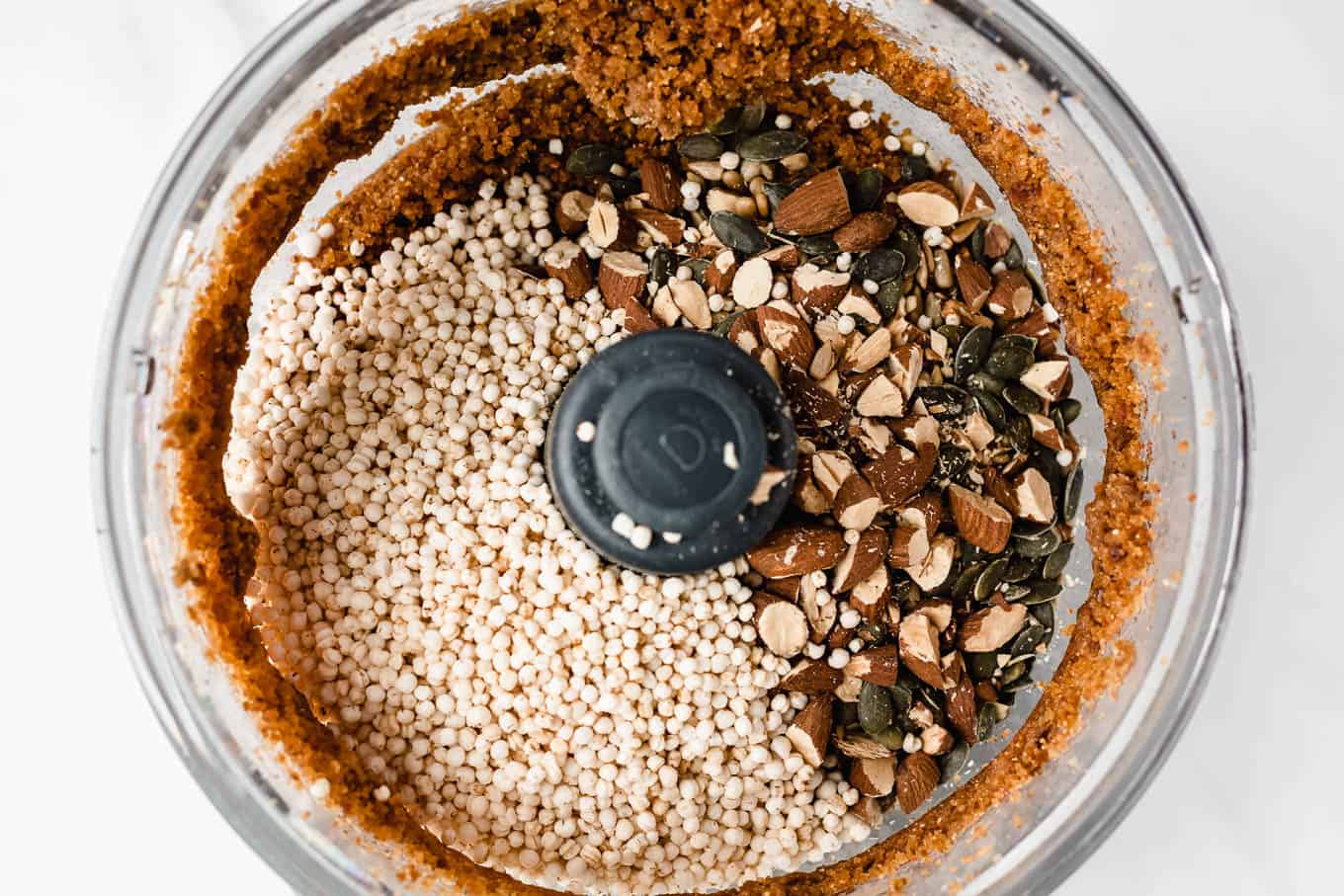 puffed quinoa and nuts in a food processor