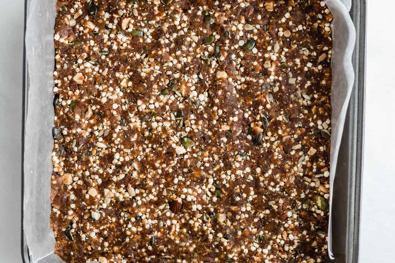 Quinoa date bars pressed into a pan
