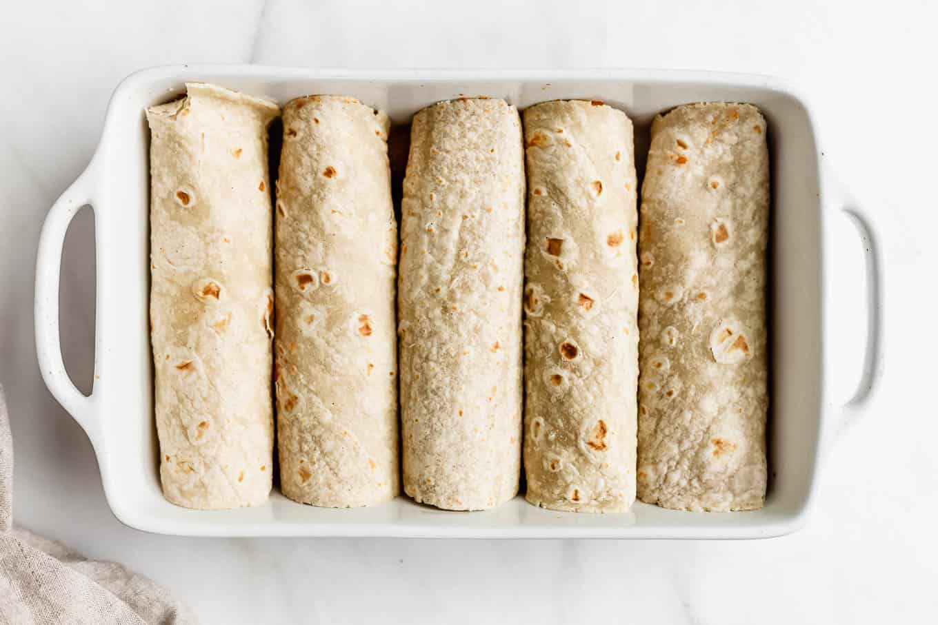 tortillas rolled up in a baking dish