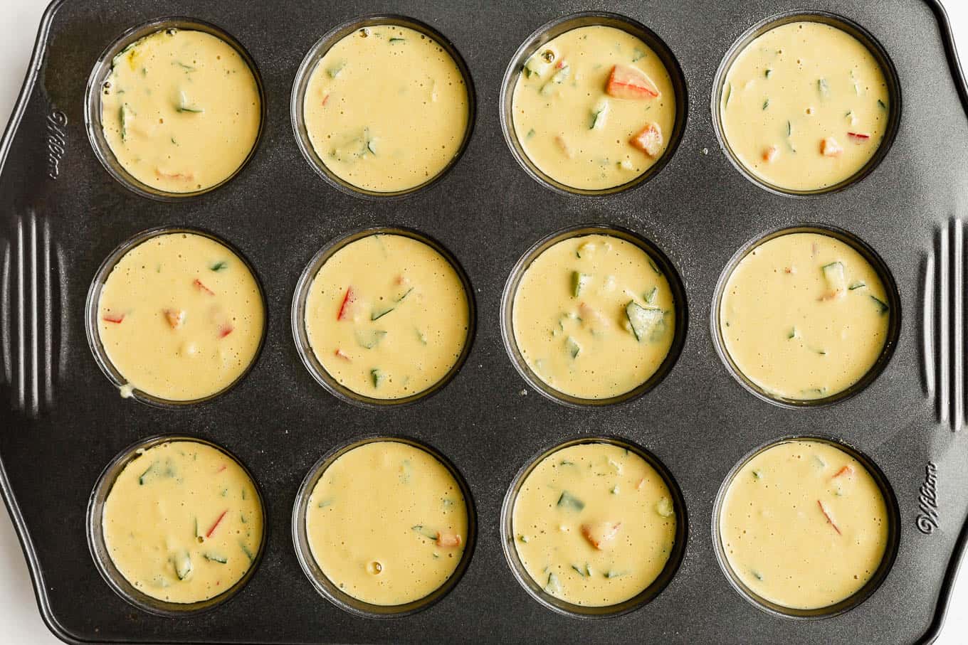 a baking pan filled with chickpea flour quiche batter