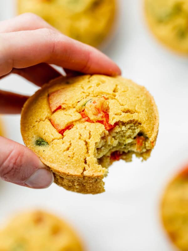a hand holding a chickpea mini quiche