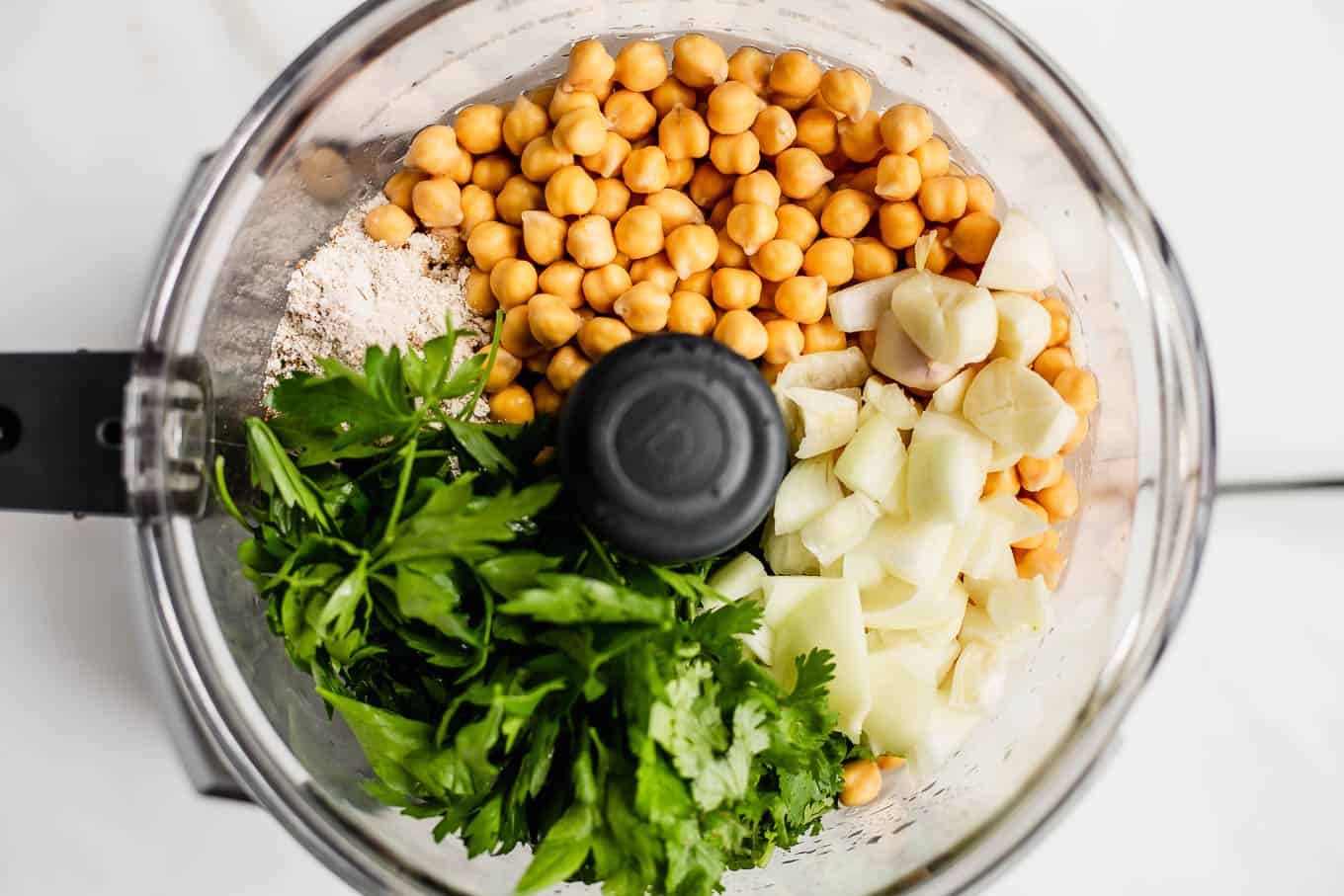 chickpeas, herbs, garlic and onions in a food processor