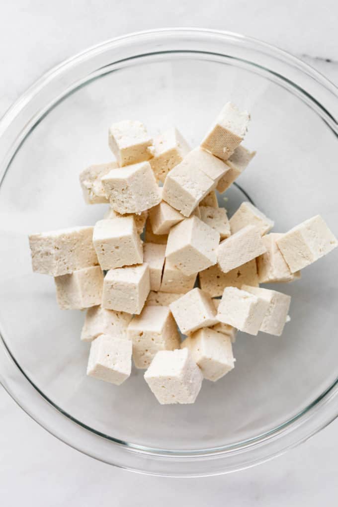 tofu cut into cubes in a clear bowl