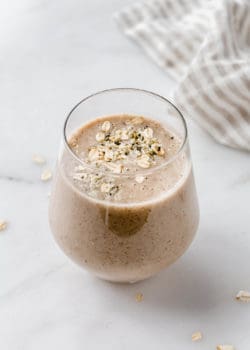 A banana bread smoothie topped with oats
