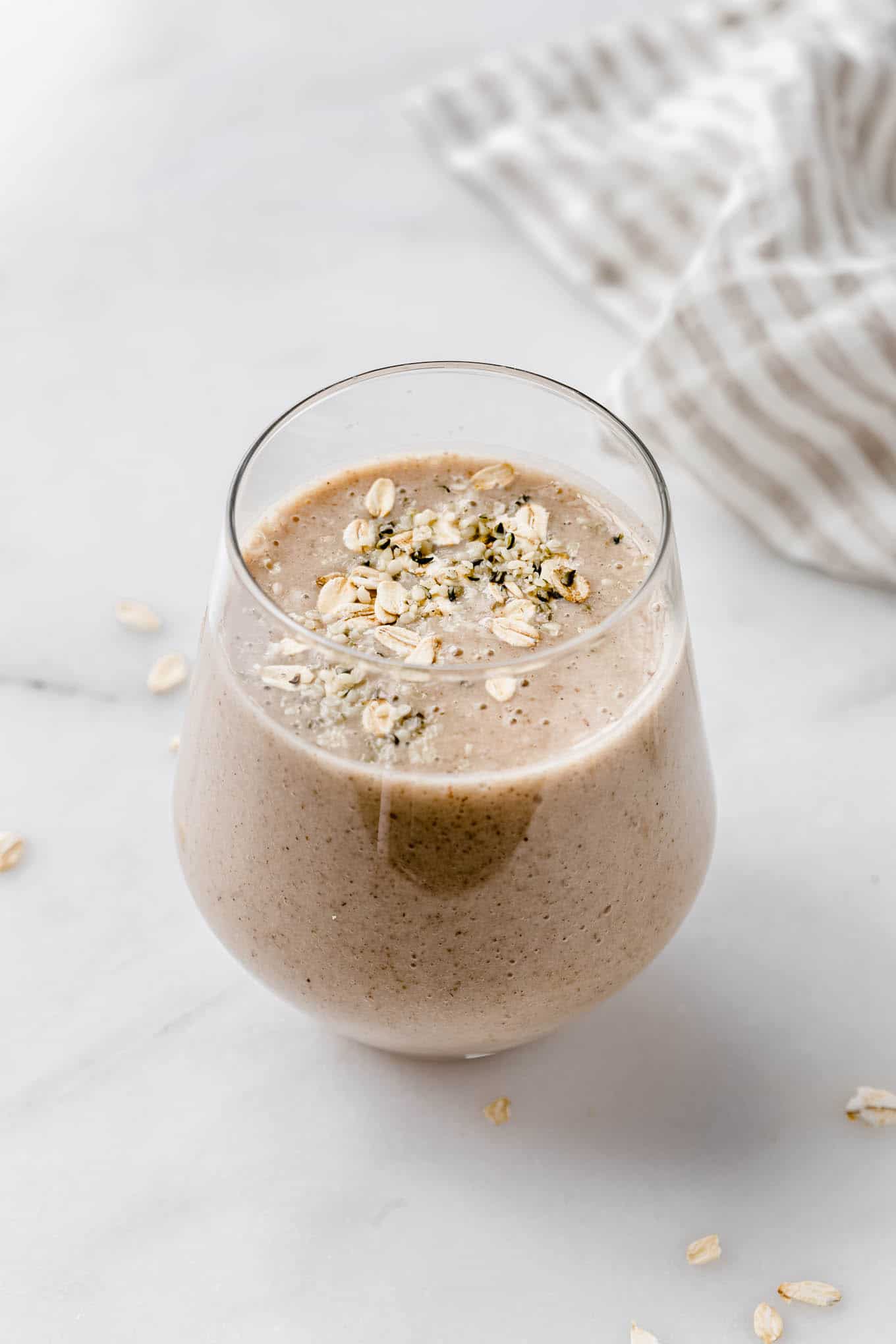 A banana bread smoothie topped with oats