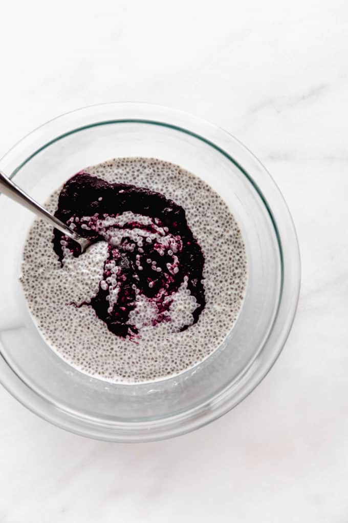 chia pudding and blueberry compote in a clear mixing bowl