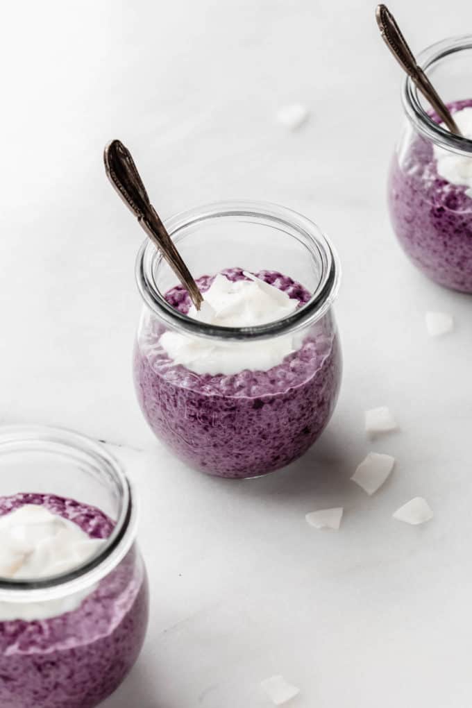 blueberry chia pudding in a small cup with a spoon in it