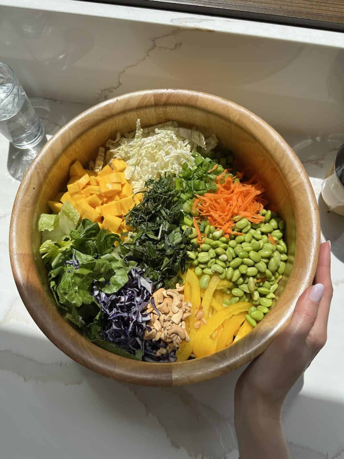 Mixed vegetables in a wood mixing bowl.