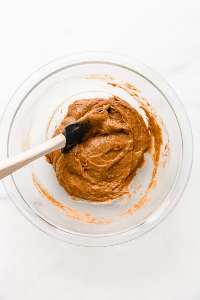 A bowl of almond butter with a spatula in it