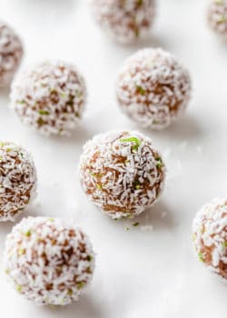a key lime pie energy ball with shredded coconut and lime zest on it