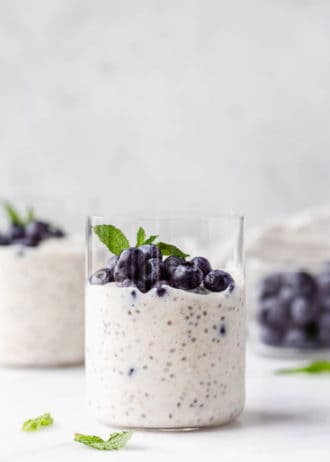 A cup with overnight oats topped with blueberries