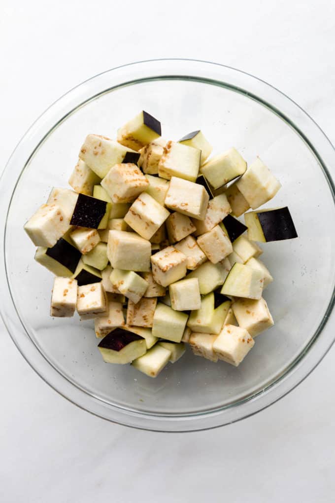 cubed eggplant in a clear mixing bowl